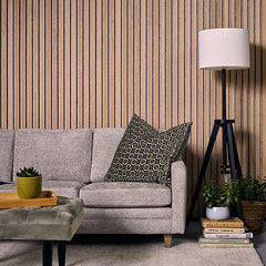 Wide slat 3-sided premium oak on grey felt acoustic wall panels installed in a modern living room creating a stylish feature wall with improved sound absorption solid furniture UK