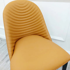Detailed view of the comfortable tan seat and ribbed stitching design of Alba Dining Chair by Solid Furniture UK