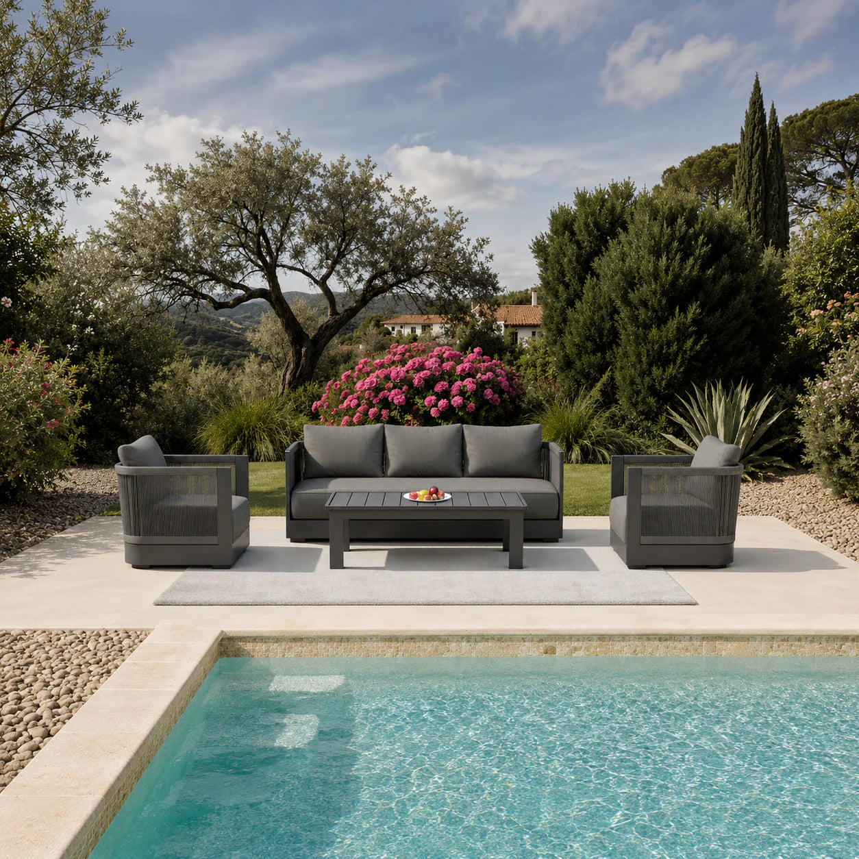 Ares Onyx 5 seater outdoor garden lounge set in a luxury garden with swimming pool in front and greenery background solid furniture UK
