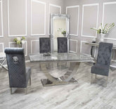 Arial chrome marble effect dining table with Sofia dark grey velvet chairs, main front view showing full dining set with chrome pedestal base and luxury velvet seating. solid furniture uk