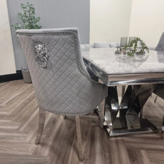 Side view of Bentley dark grey chrome velvet dining chair UK placed beside dining table showing elegant profile and chrome legs from Solid Furniture UK