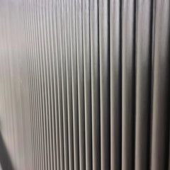 Side view of black fluted WPC wall panels by Solid Furniture UK showing the depth and vertical panel design