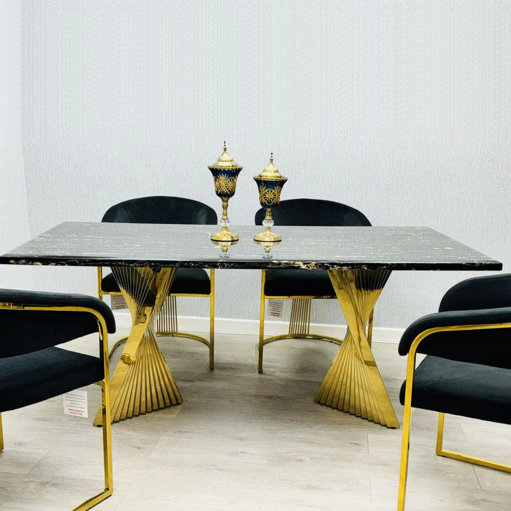 Black and gold Ravello 160cm marble-effect dining table with gold pedestal base, paired with elegant Porado dining chairs in a modern luxury dining room setting. solid furniture UK