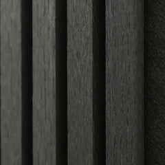 Close-up of Black Oak acoustic wall panel showing real wood veneer wrapped on three sides with premium finish and acoustic felt detail. solid furniture UK