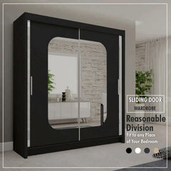 Black sliding wardrobe with mirrored doors styled in a contemporary bedroom