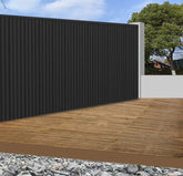 Black WPC outdoor wall panels 180cm and 290cm installed in a modern UK garden setting by Solid Furniture LTD, showcasing sleek and durable exterior wall design
