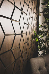 Side view of walnut acoustic wall panel 60x240cm UK showing panel thickness and slatted profile detail. solid furniture UK