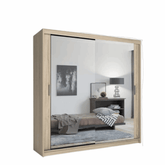 Oak sliding door wardrobe with mirror doors in a modern bedroom setting