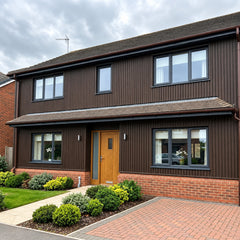 Dark brown WPC wall panels 180/290cm installed on two-storey house exterior wall – Solid Furniture UK