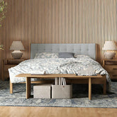 Bedroom interior in the UK featuring dark oak HDF acoustic slatted wall panels 60x240cm by Solid Furniture UK, adding warmth and improved sound control.