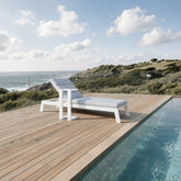 Dasia white sun lounger styled in a modern UK poolside outdoor living space from Solid Furniture UK