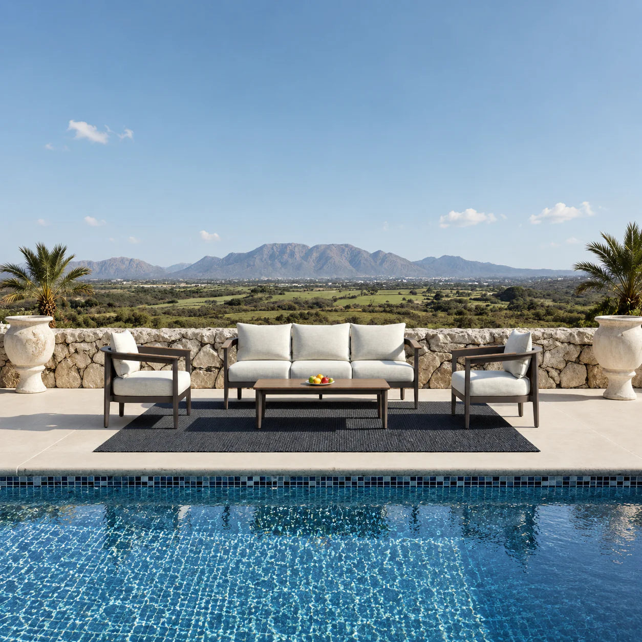 Hemera Wood 5 seater outdoor garden lounge set with sofa, chairs and coffee table, featuring mountain hills background and luxury pool view in a modern patio setting solid furniture UK