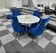 Angled perspective of luxury dining set by Solid Furniture UK showing marble table and velvet chairs in modern dining space