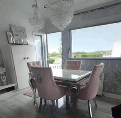 Side angle view of Louis white marble dining table with pink Majestic velvet dining chairs from Solid Furniture UK