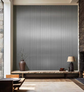 Metallic dark grey slatted wall panels installed on a modern living room wall, showing full wall coverage and sleek, contemporary design. solid furniture UK