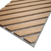 Full view of chevron slat acoustic wall panel by Solid Furniture UK in oak finish on grey felt backing for interior feature walls