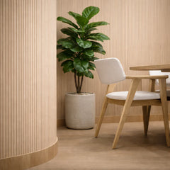 Flexible Oak Slat Wall Panels installed on a modern living room feature wall, showcasing seamless veneer finish and warm oak texture with soft ambient lighting solid furniture UK