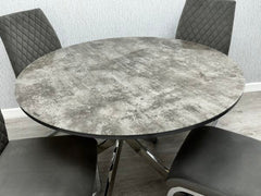 Close-up of the Tokyo dining table showing the grey stone effect glass tabletop and modern base from Solid Furniture UK.