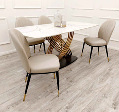 Orion Gold 1.8m dining table with Etta beige leather dining chairs side angle view at Solid Furniture UK