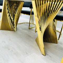 Close up of Ravello Black and Gold Marble Dining Table gold metal base, sturdy modern dining table UK by Solid Furniture UK