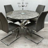 Tokyo round dining set featuring a grey stone effect glass table and four grey velvet chairs from Solid Furniture UK.