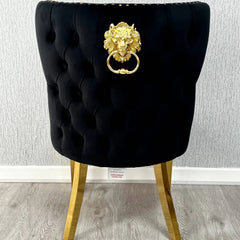 Back side view of Valentino black velvet dining chair featuring lion head knocker detail, gold-finished legs and luxury upholstered design by solid furniture uk
