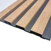 Close-up view of Solid Furniture UK waterproof light oak slatted WPC wall panels, showcasing the natural wood-effect texture and modern slatted design.