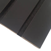 Close-up of wide slat 3-sided black wall panel showing smooth textured finish, bold black color, and acoustic felt backing for a modern, sleek look solid furniture UK
