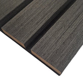 Close-up of wide slat 3-sided wood veneer acoustic wall panel in premium black oak showing rich texture, smooth finish, and sleek slat design solid furniture UK