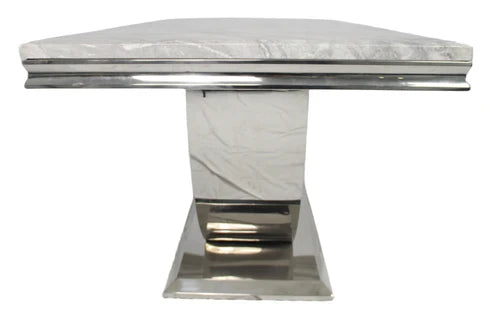 Arial Detailed view of white marble dining table highlighting elegant tabletop and sturdy base solid furniture UK