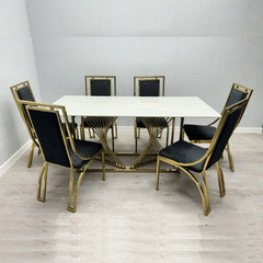 Amelia white ceramic dining table with gold Windsor chairs from Solid Furniture UK in a modern dining room