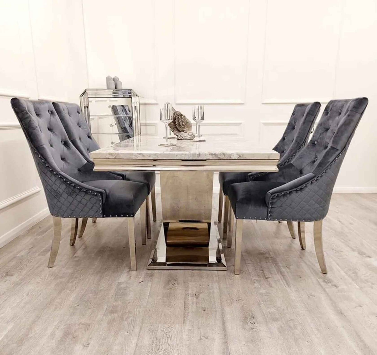 Side view of Arial marble dining table with chrome base and Majestic velvet dining chairs modern dining set Solid Furniture UK