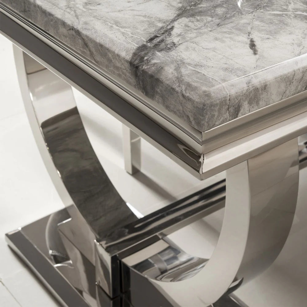 Close-up side view of Arriana dining table showing beige marble surface and chrome frame detail by Solid Furniture UK