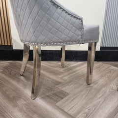 Close up view of chrome legs on Bentley dark grey velvet dining chair UK showing curved design and sturdy metal finish from Solid Furniture UK
