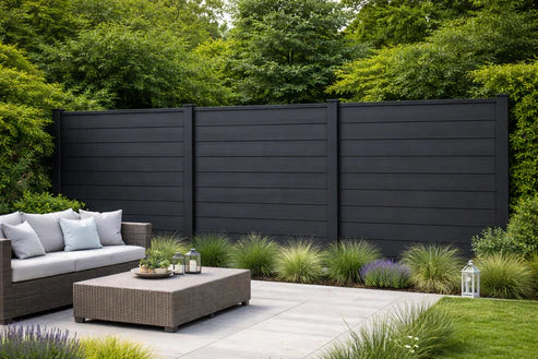 Black Composite Fence Panels installed around a contemporary patio from Solid Furniture UK
