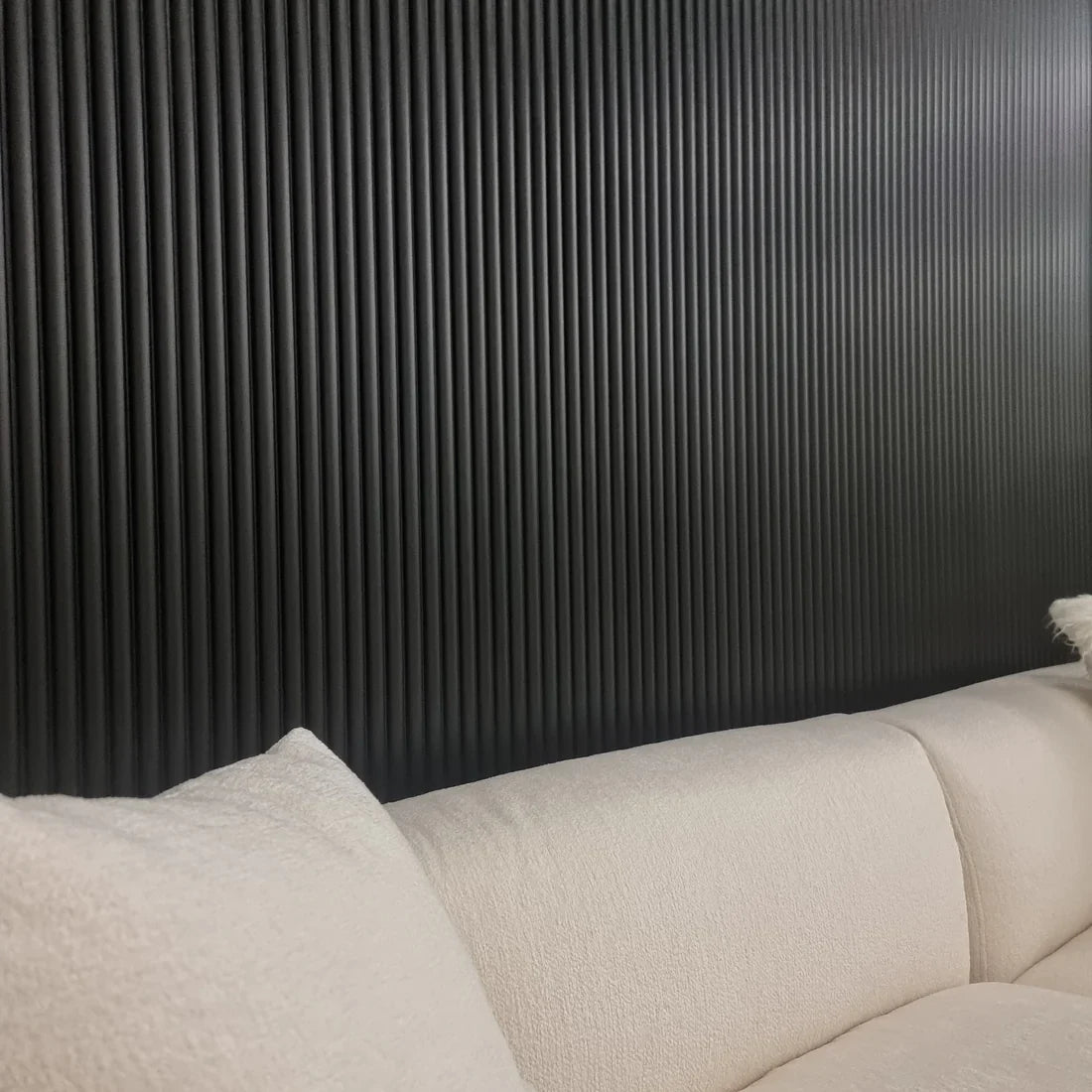 Side view of black drawing room wall panels installed by Solid Furniture UK highlighting the modern interior cladding style