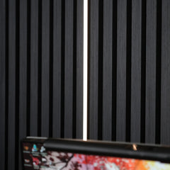 Black acoustic slatted wall panels 60x240cm with LED strip lighting in the UK by Solid Furniture UK, creating a stylish and ambient interior design.