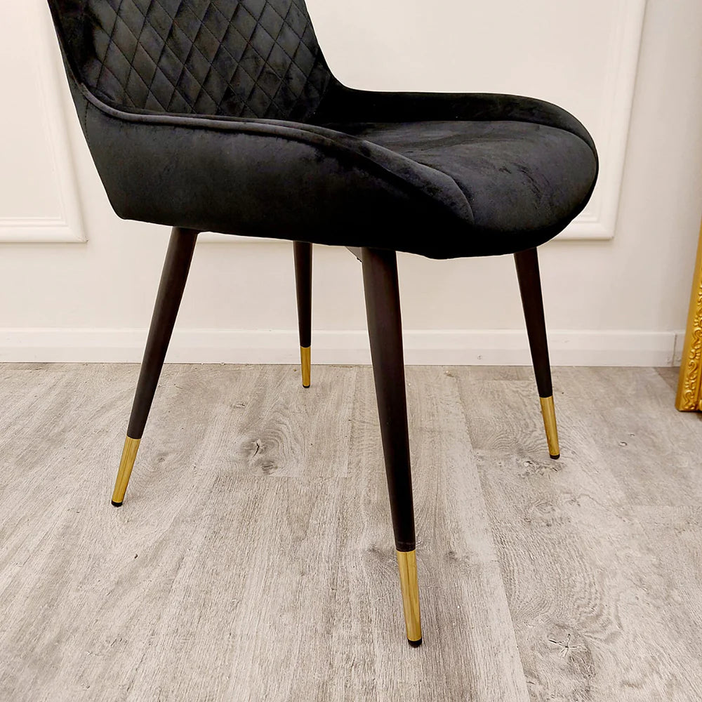 Close up of Black Luna dining chairs legs from Solid Furniture UK featuring black finish with gold tipped modern design