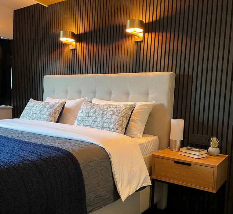 Black Oak acoustic slatted wall panels installed in a modern living room, showcasing a sleek dark wood finish with sound-absorbing design. solid furniture UK
