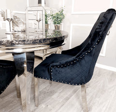 Black Round Lewis dining table with 4 Majestic black velvet chairs from Solid Furniture UK – main front view