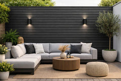 Black waterproof outdoor cladding installed on a garden wall by Solid Furniture UK