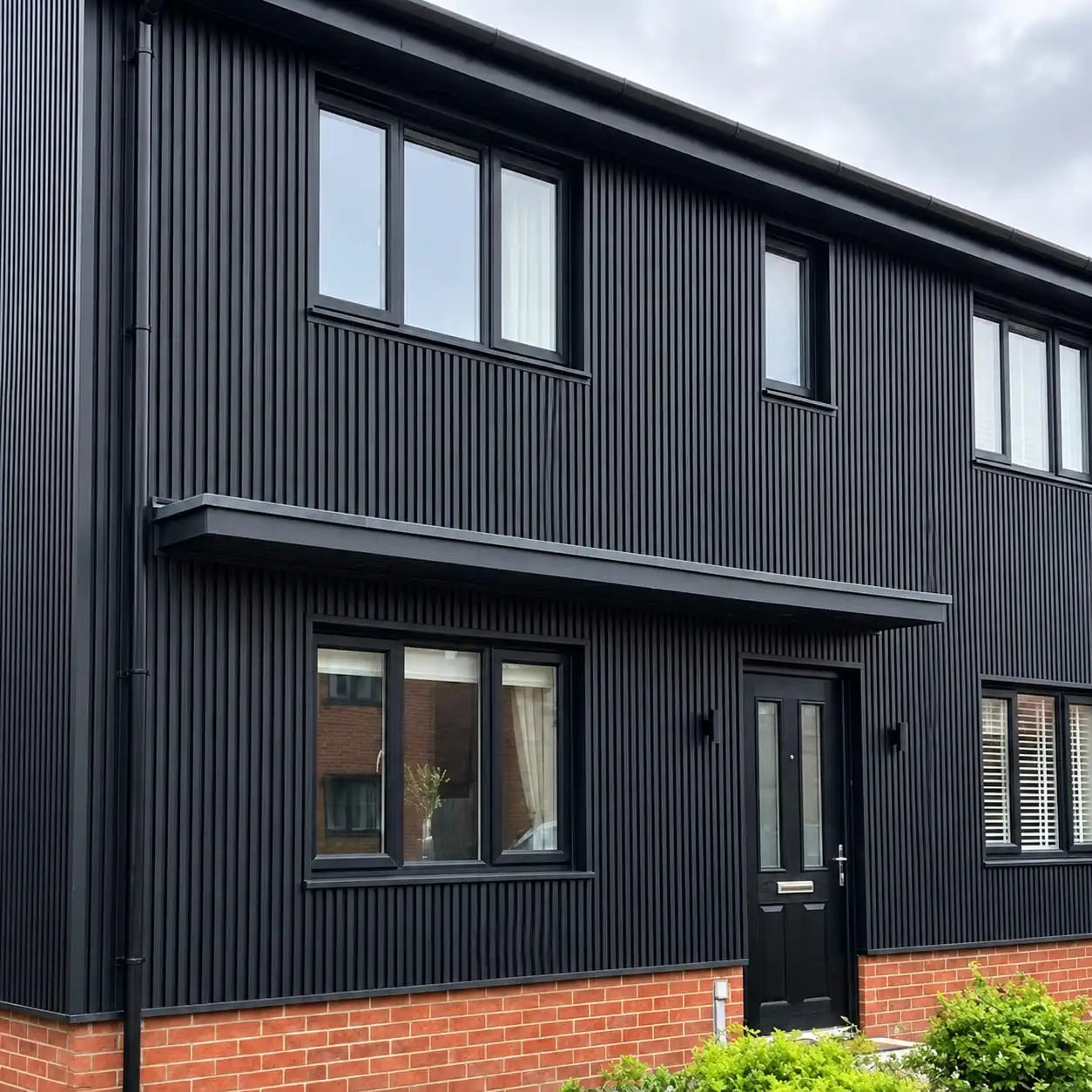 Black waterproof WPC wall panels 180/290cm installed on a house exterior by Solid Furniture UK