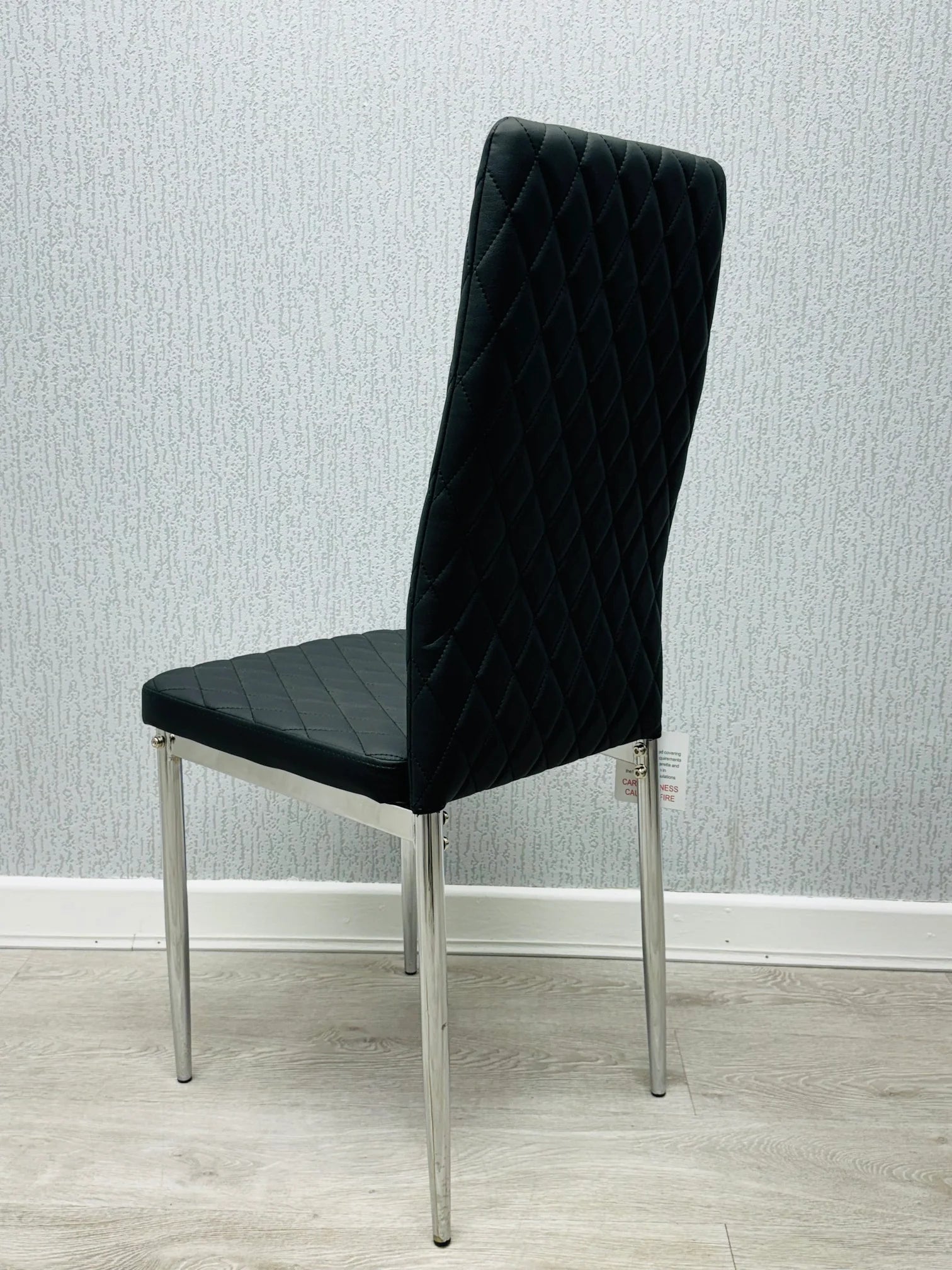 Back view of black California PU Dining Chair showing modern structure and sturdy chrome legs by Solid Furniture UK