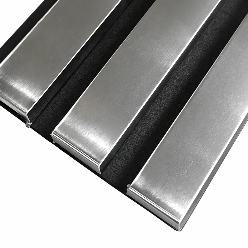 Close-up of chrome 3-sided acoustic slat wall panel 32 x 240 cm showing slat texture, spacing, and grey felt backing for acoustic absorption solid furniture UK