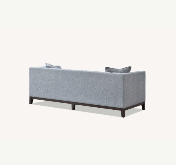 Back view of Cooper 3 seater sofa in dolphin grey bouclé fabric showing wooden plinth solid furniture UK