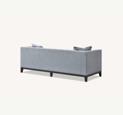 Back view of Cooper 3 seater sofa in dolphin grey bouclé fabric showing wooden plinth solid furniture UK