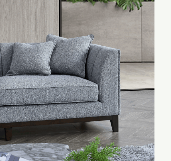 Left-hand corner view of Cooper dolphin bouclé sofa with mid-century design solid furniture UK