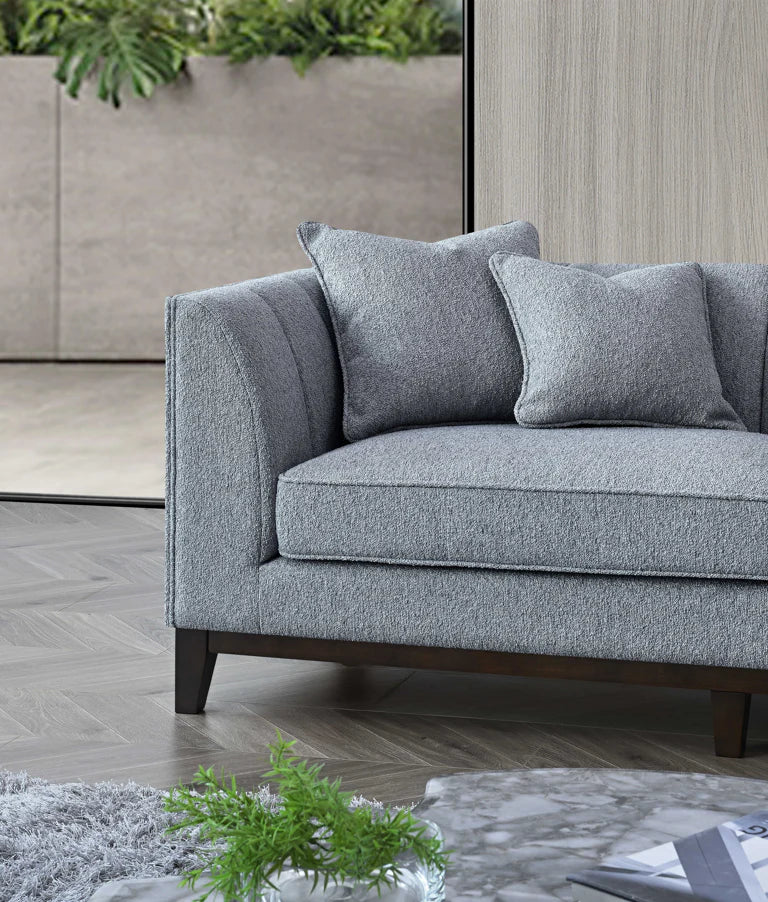 Right-hand corner view of Cooper dolphin bouclé sofa with mid-century design solid furniture UK
