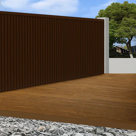 Dark brown WPC outdoor wall panels 180cm and 290cm installed in a modern UK garden setting by Solid Furniture LTD, showcasing rich wood-tone exterior wall design