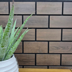 Close-up of 60x240 dark oak brick wall panel UK showing detailed slatted brick pattern, precise spacing, and high-density fiberboard construction. solid furniture UK
